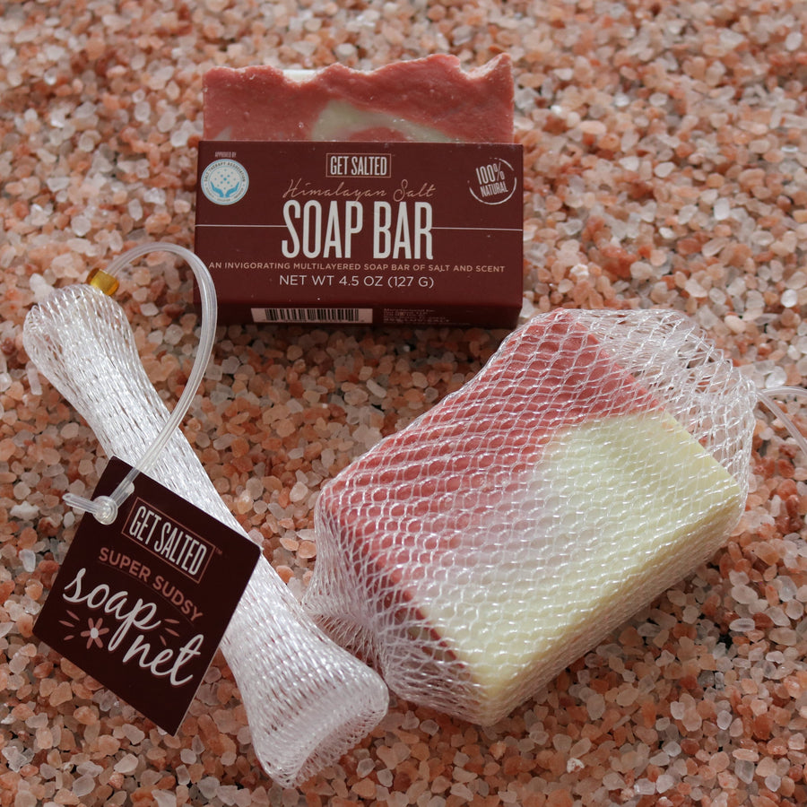 Soap bar and mesh bag on a pink salt background with 'Get Salted' branding.
