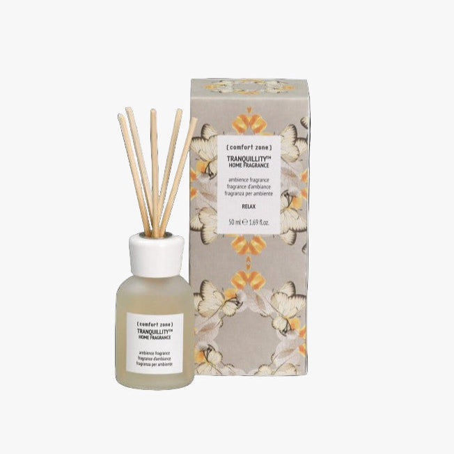 Diffuser bottle with wooden sticks and decorative packaging on a white background